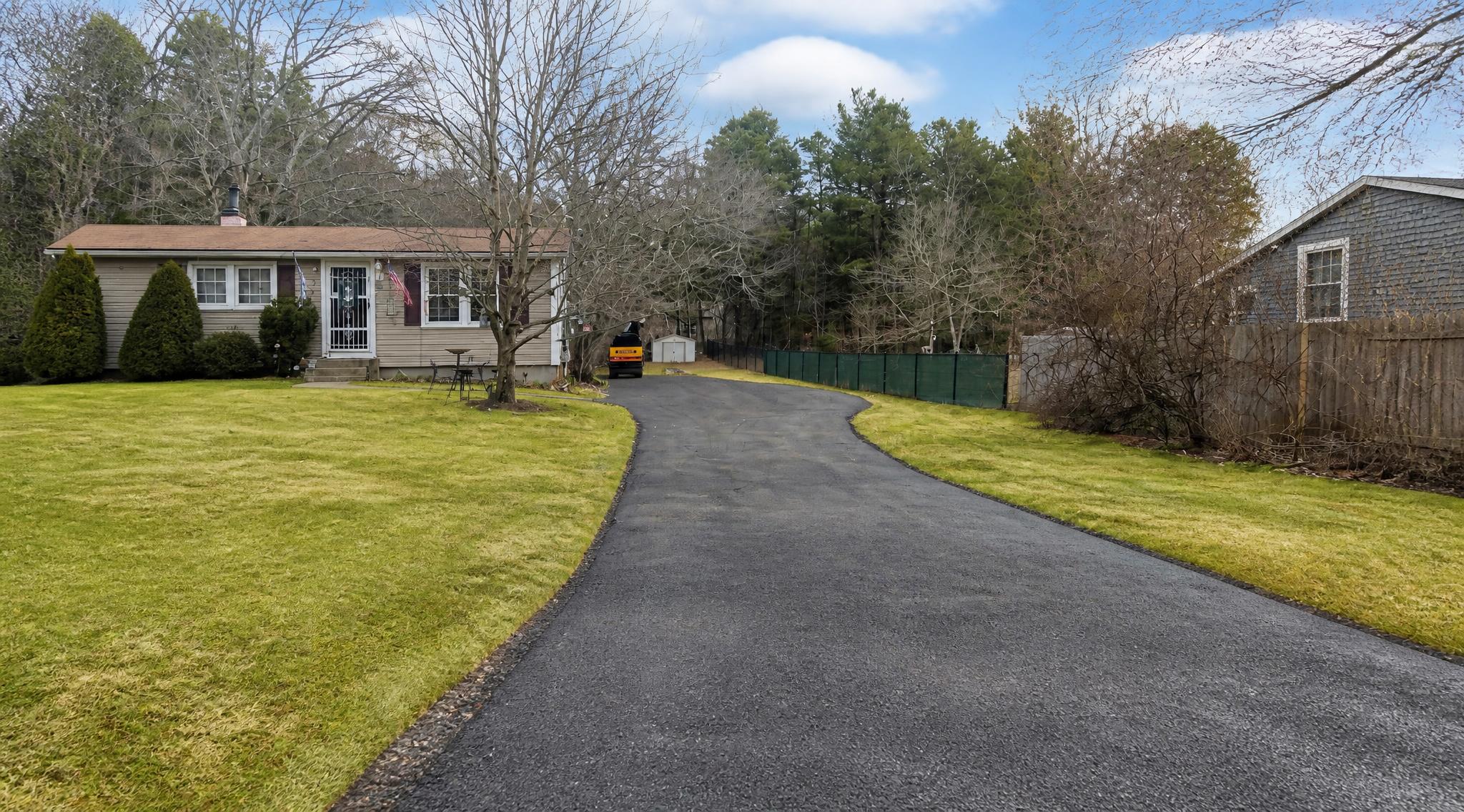 Sealcoating a Worn but Usable Asphalt Driveway With the Family Driveway Company